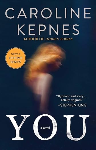 You by Caroline Kepnes, a thriller book cover featuring a blurred silhouette of a person with long red hair against a dark blue background.