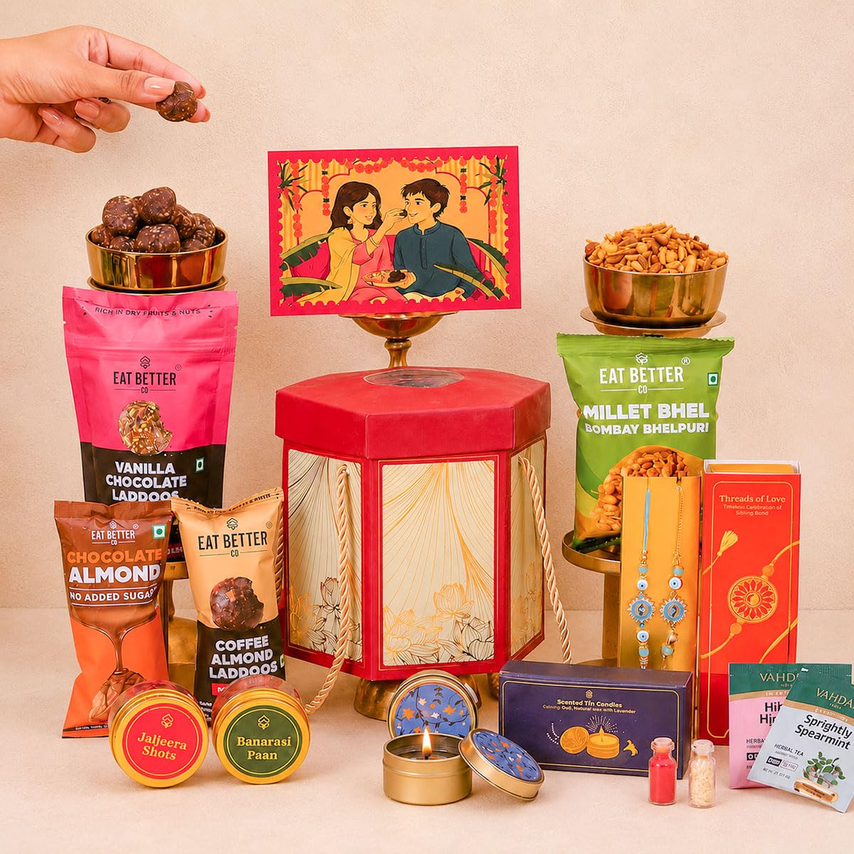 Pyaar Ka Pitara 14-Item Rakhi Gift Hamper for Brother and Bhabhi - Bhaiya Bhabhi Rakhi Set, Evil Eye & Lumba Rakhi, Roli-Chawal, Dry-Fruit Laddoos, Choco-Nuts, Candles, Mukhwas, Tea & more