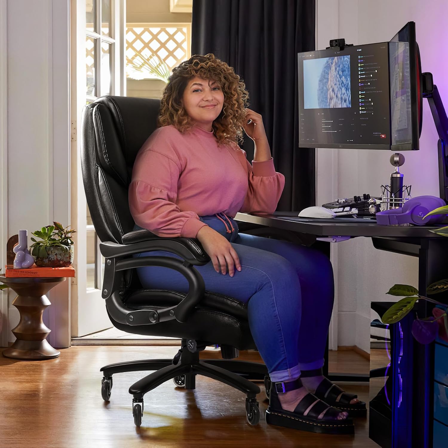 Person comfortably seated in the VITESSE Heavy Duty Office Chair, demonstrating its spacious design