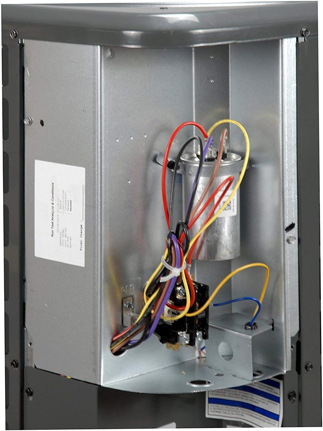 Close-up of the electrical wiring and capacitor inside the Goodman GLXS4BA4810 AC Condenser