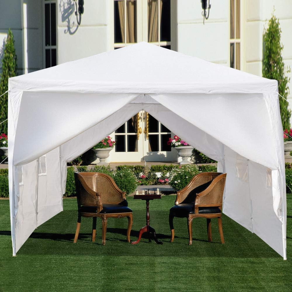 White gazebo tent set up in a backyard with patio furniture