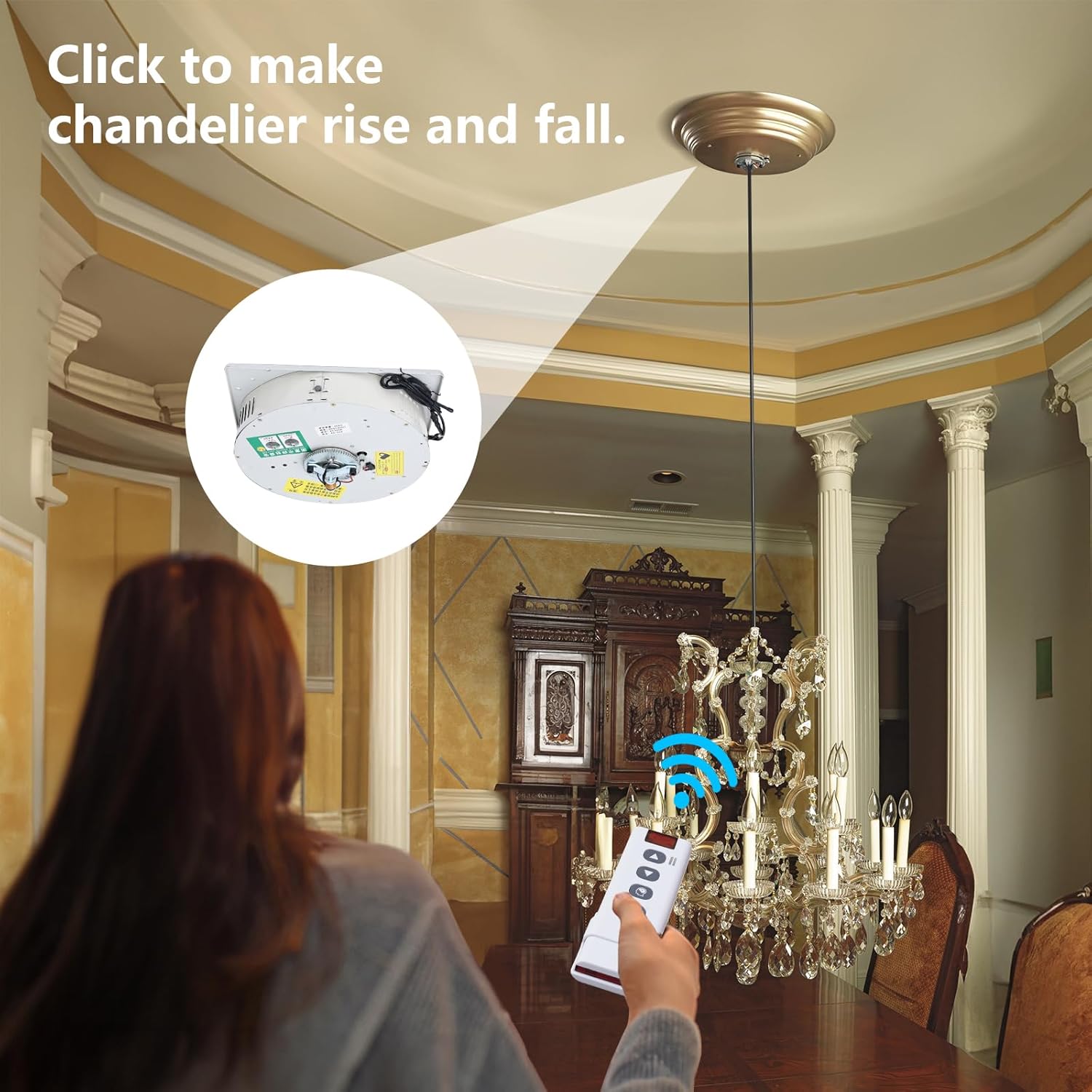 A person using the remote control to lower a chandelier.