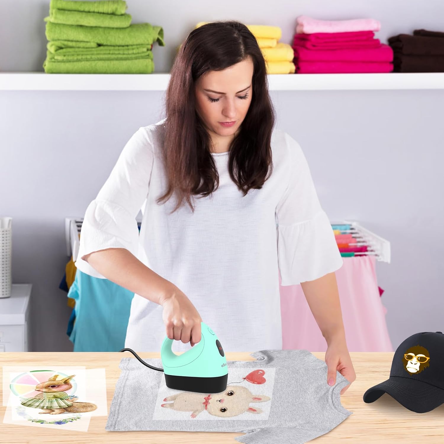 Person using the heat press to apply a design to a T-shirt.
