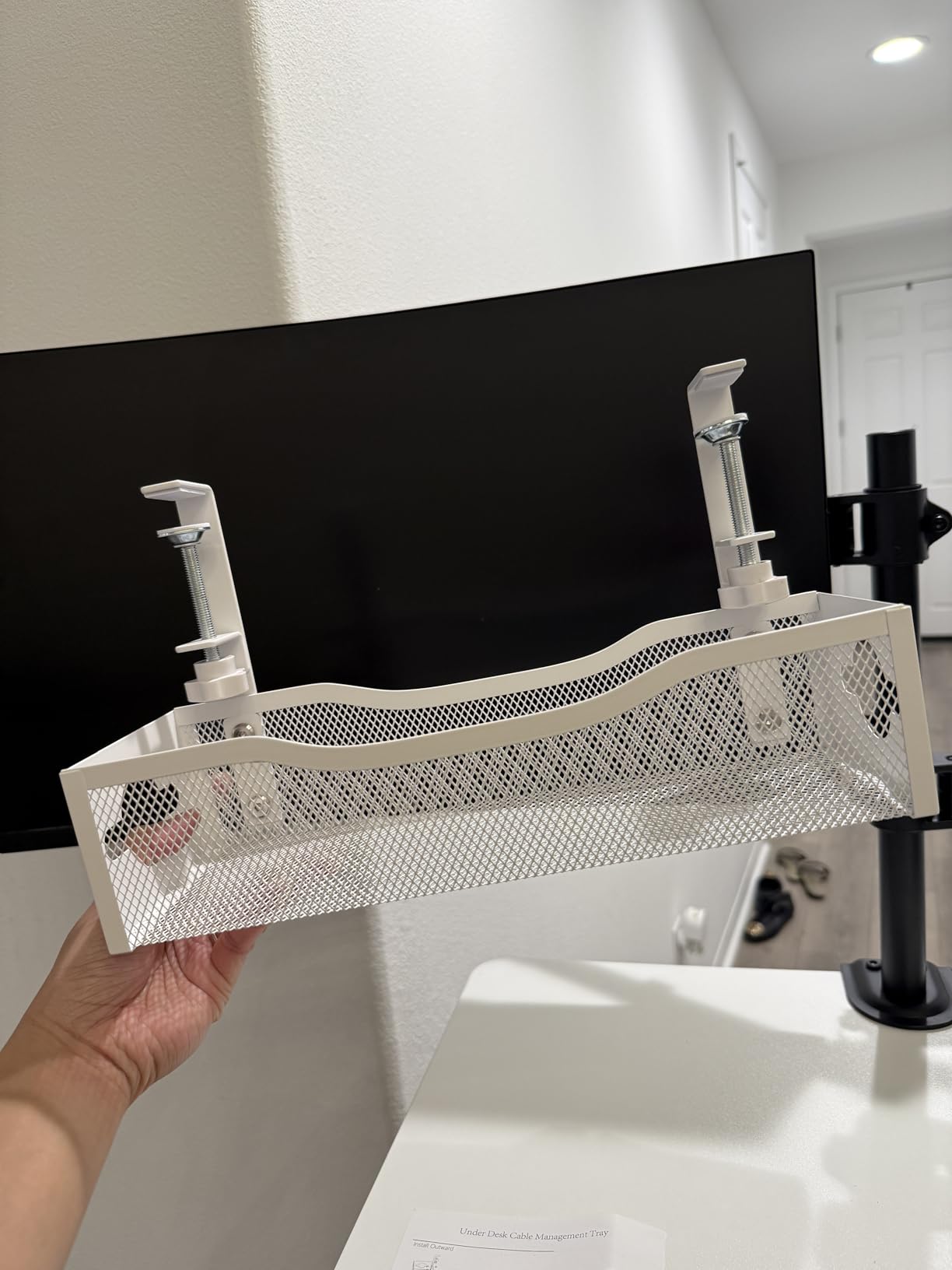 Holding the assembled cable tray to show scale