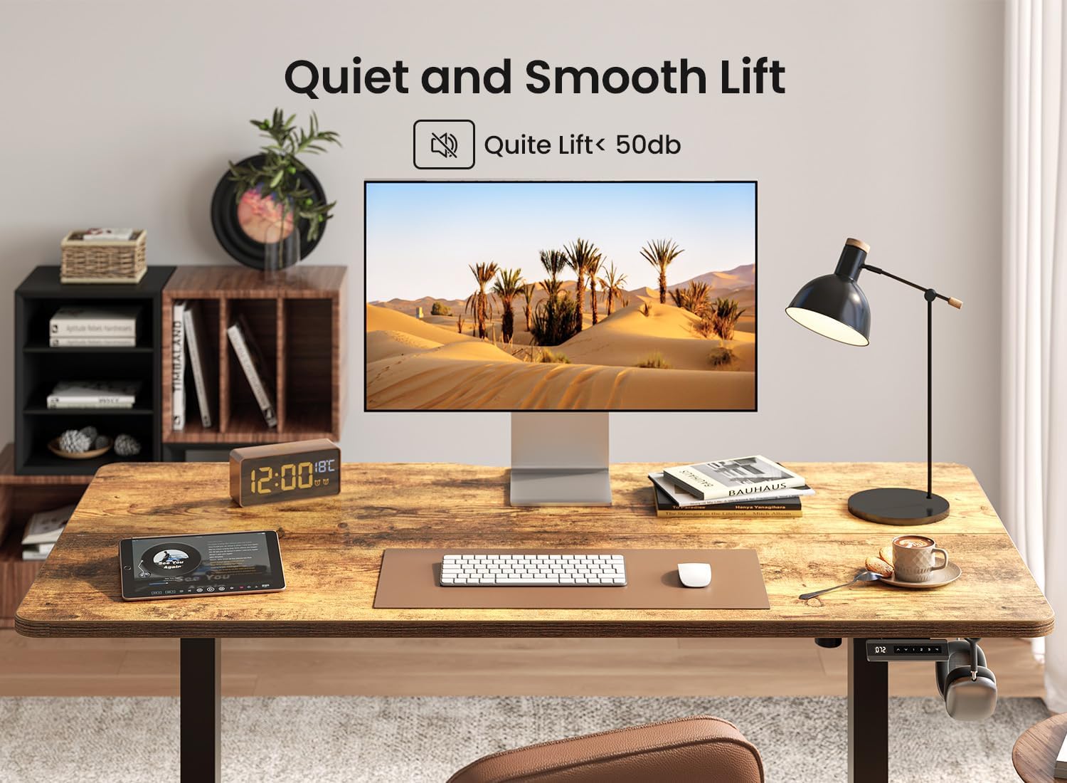 A BANTI standing desk in a home office setting, showing a monitor and other items, with text indicating 'Quiet and Smooth Lift < 50db'.