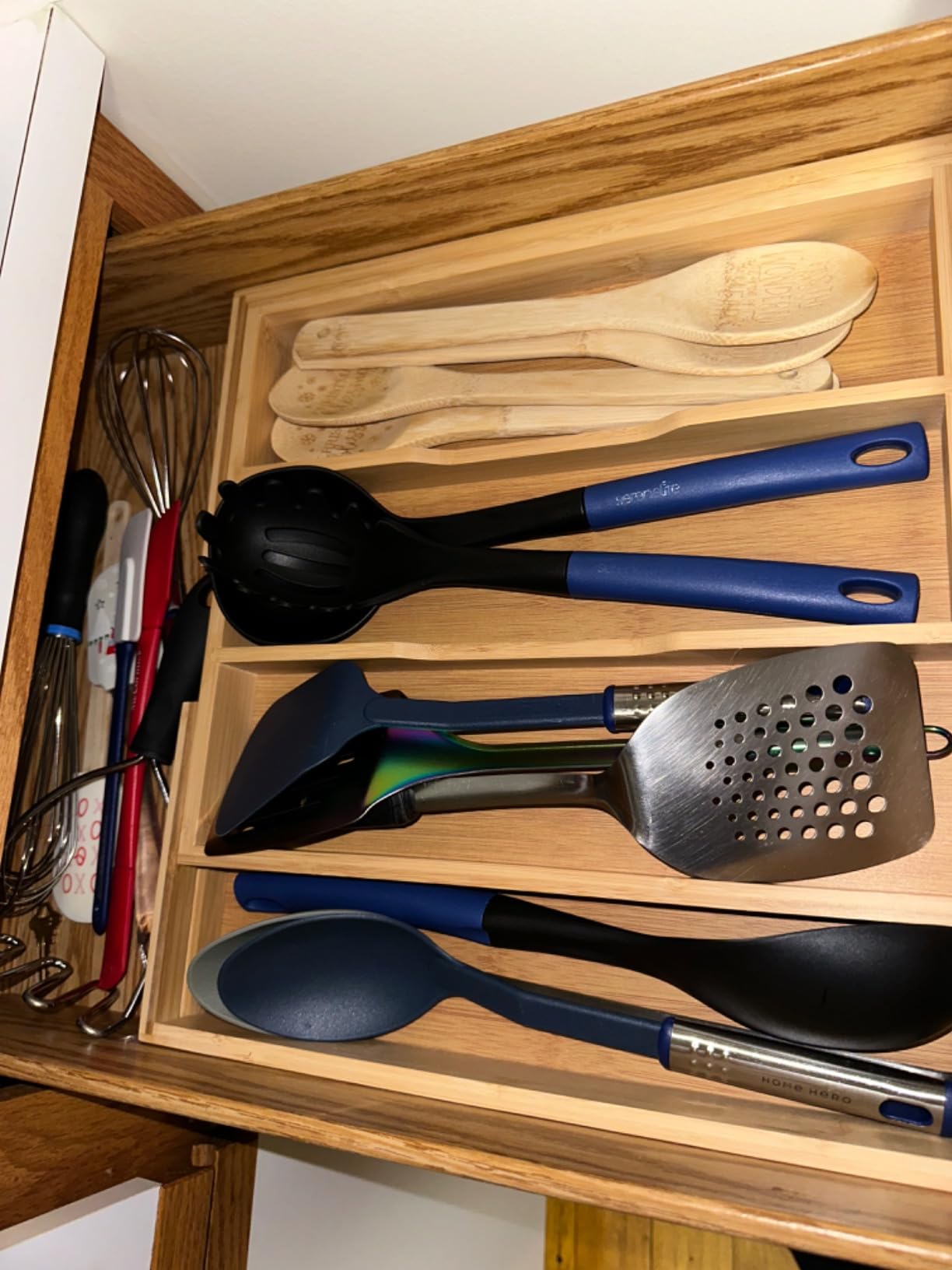 Long cooking utensils organized in a drawer tray