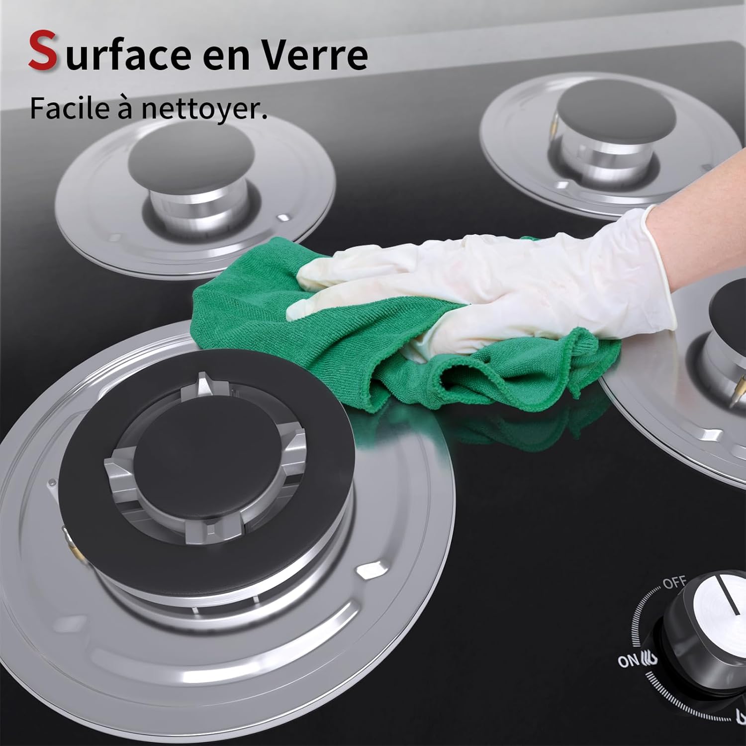 Hand cleaning the tempered glass surface of the gas hob with a cloth