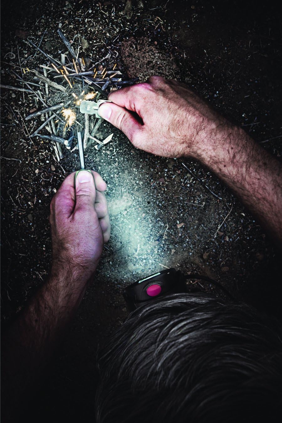 Person using the Olight H15 Wave S Headlamp to illuminate a fire starting activity