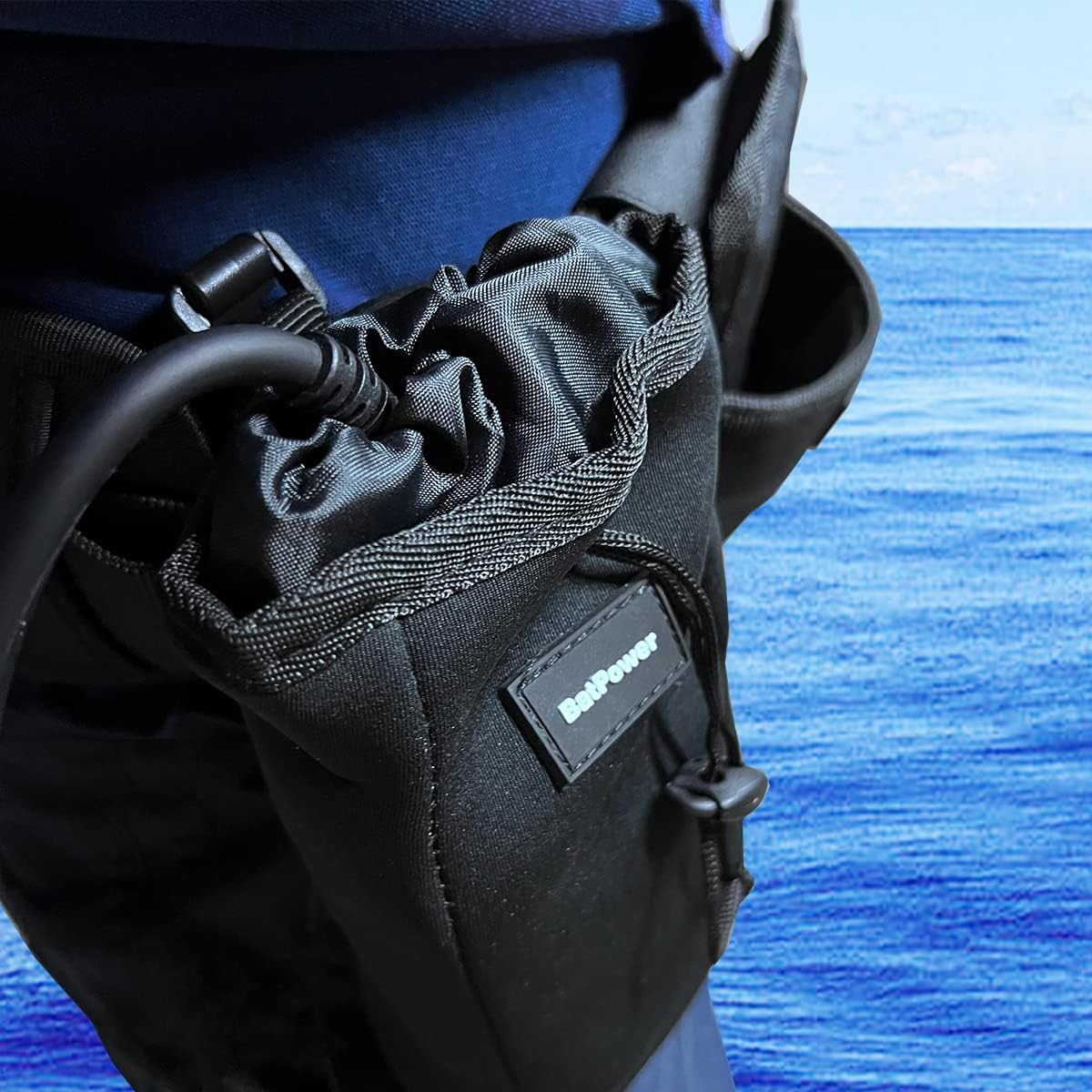 Close-up of the BatPower PROF2 battery showing the LED charge indicator and a connected power cord.