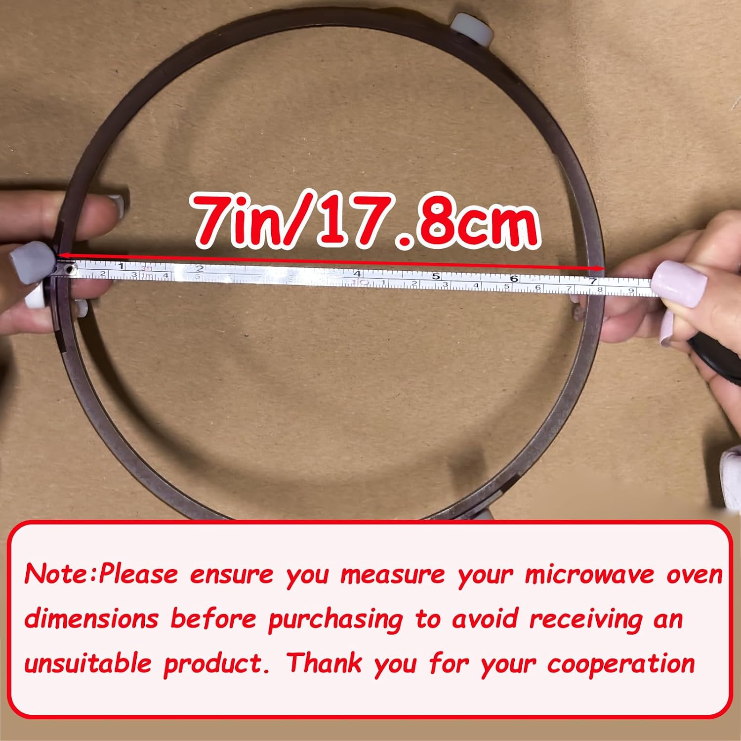 Image showing a person measuring the outer diameter of a microwave turntable ring with a tape measure, indicating 7 inches or 17.8 cm.