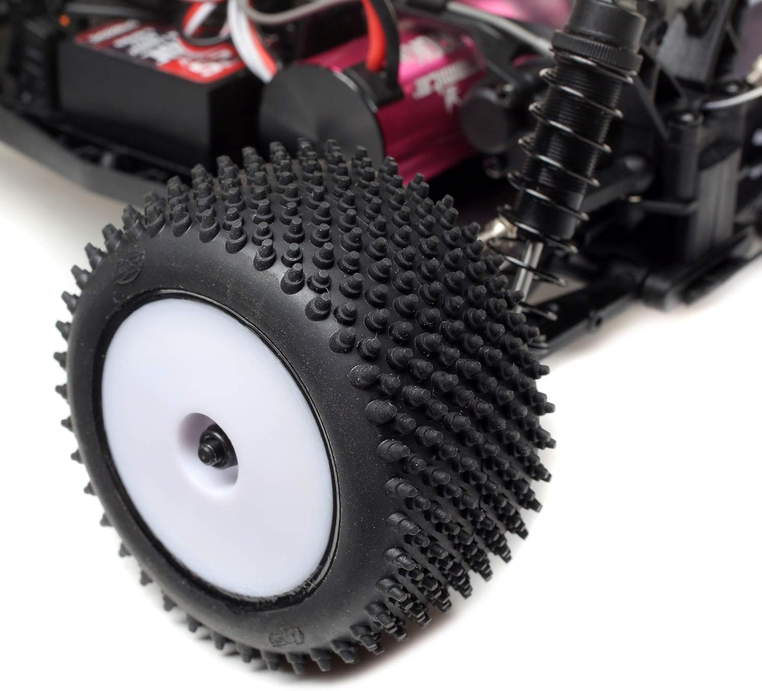 Close-up view of the knobby tire and white wheel of the Losi Mini-T 2.0 RC truck