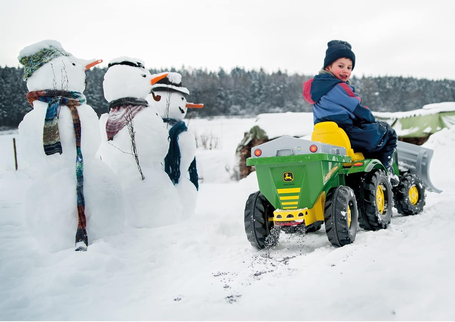 Child operating RollyStreumax trailer with pedal tractor