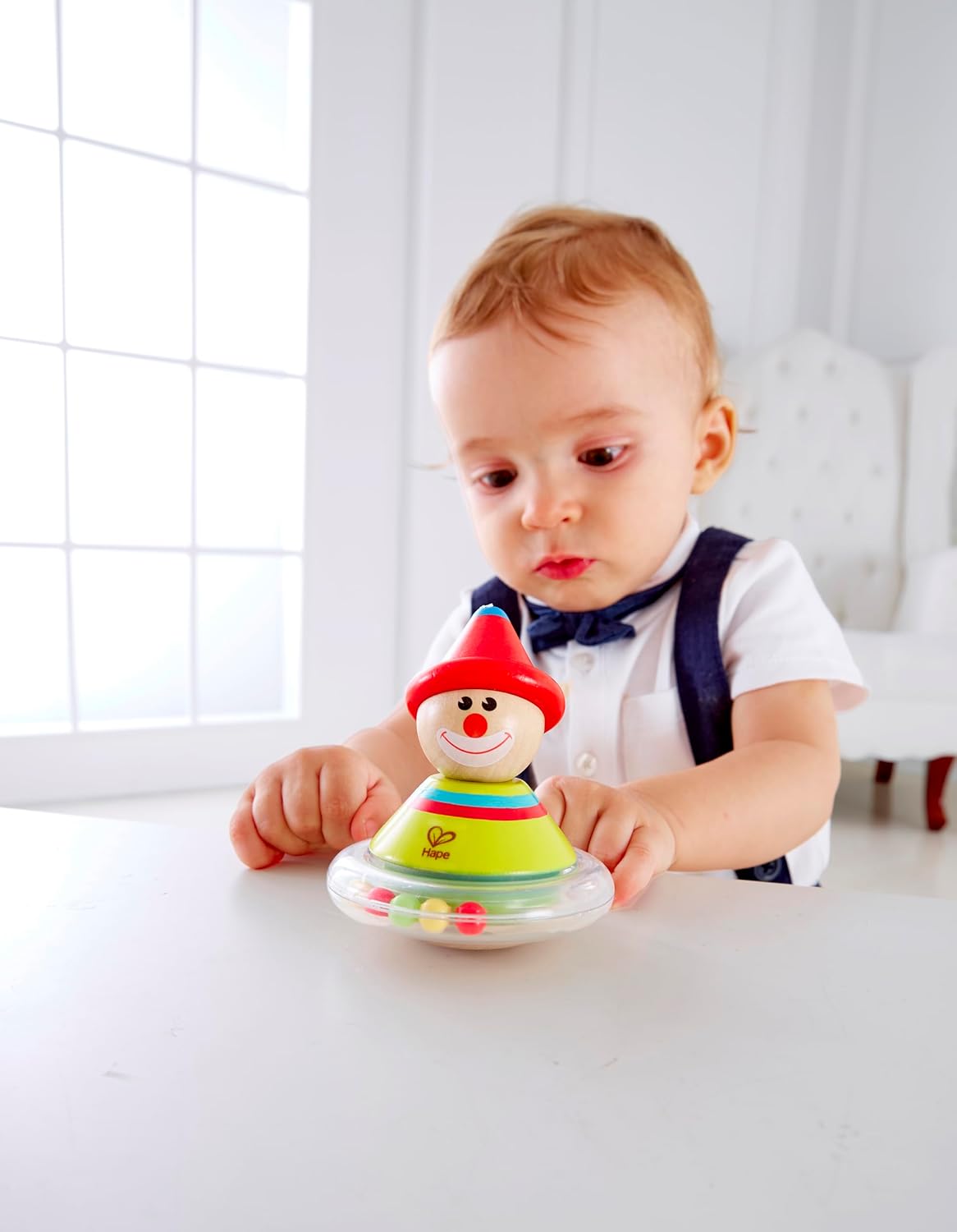 Baby playing with Hape Roly Poly Ralph toy