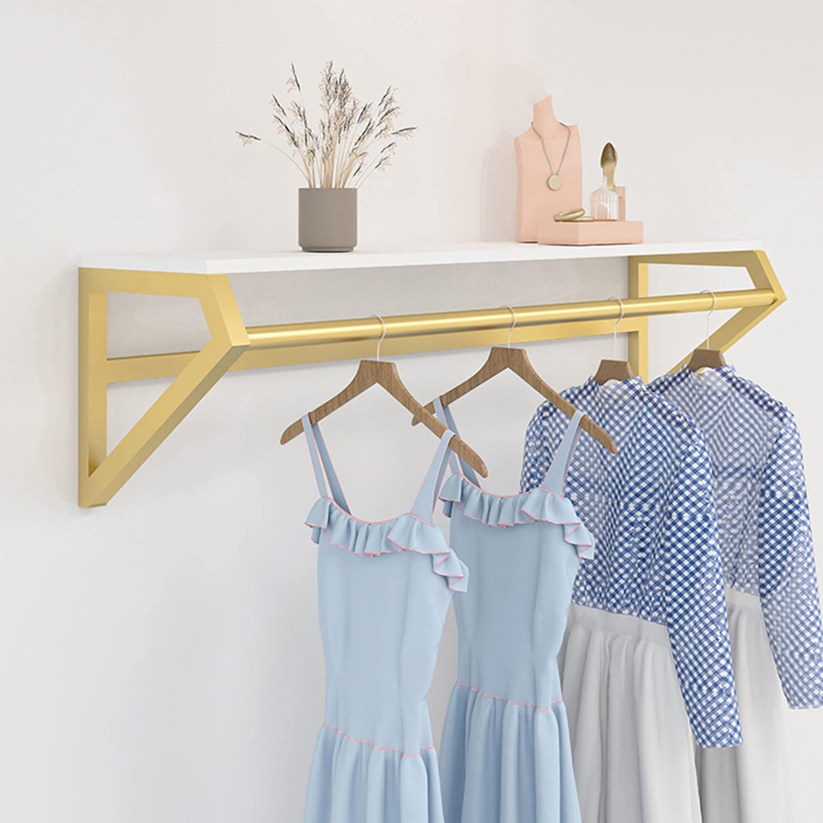 U-shaped wall mounted rack creates a floating, clean display for garments. Gold finish adds a premium touch while maximizing wall space. Custom sizes and finishes available for boutique interiors