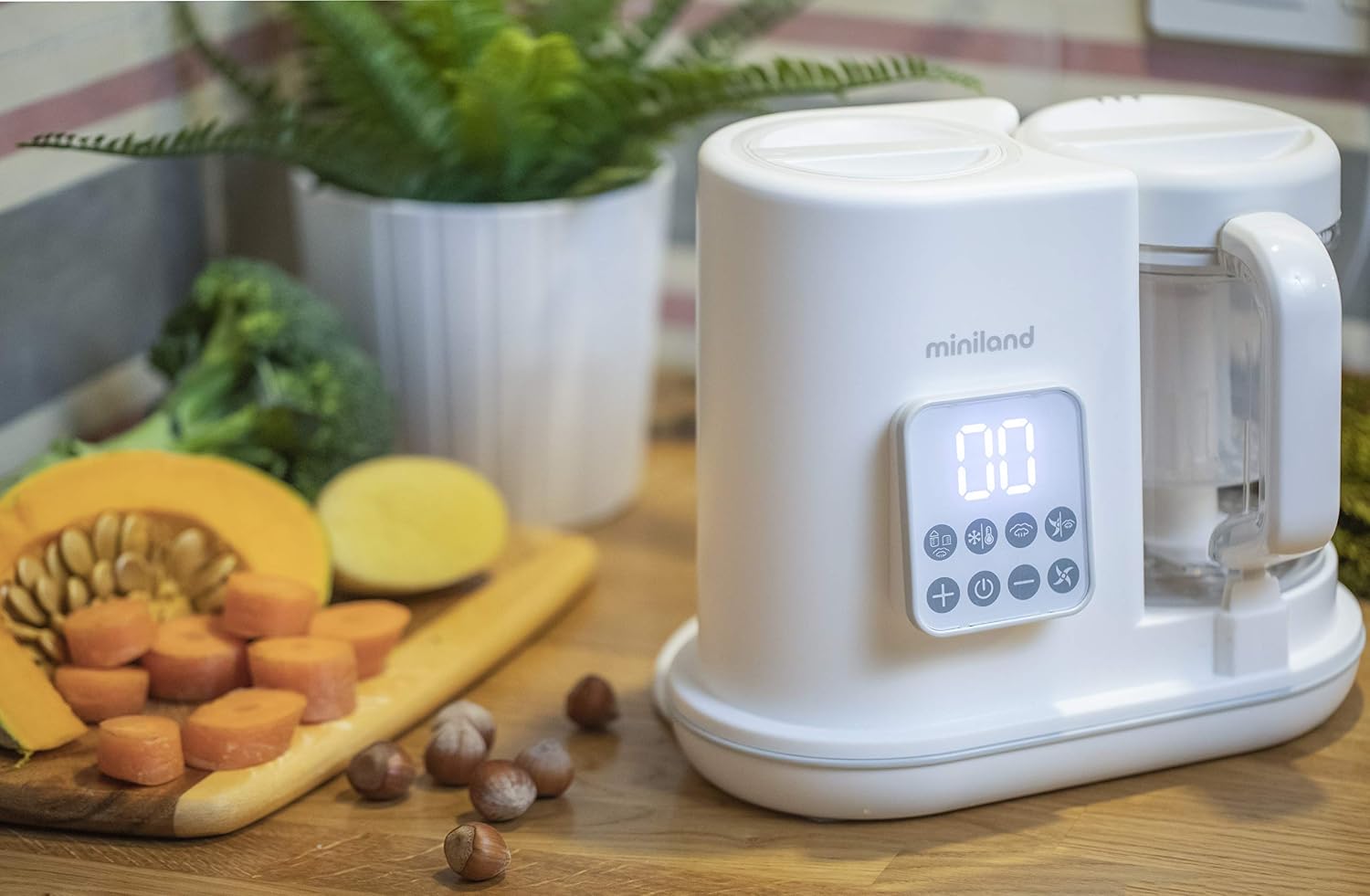 Miniland Chefy 6-in-1 Baby Food Processor with vegetables in the steaming basket, ready for steam cooking.