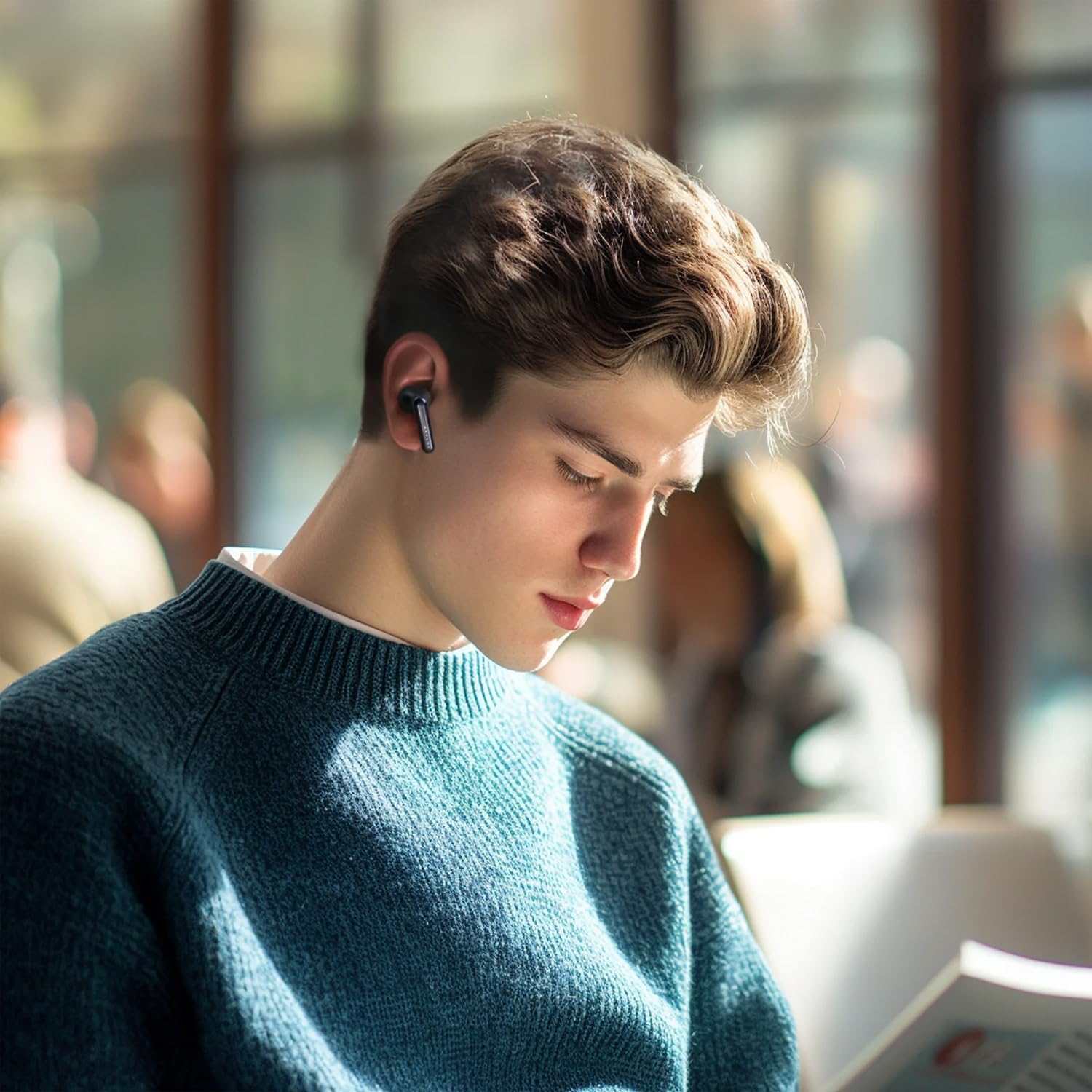Person wearing Haylou Mori Pro T016 earbud while reading in a cafe.