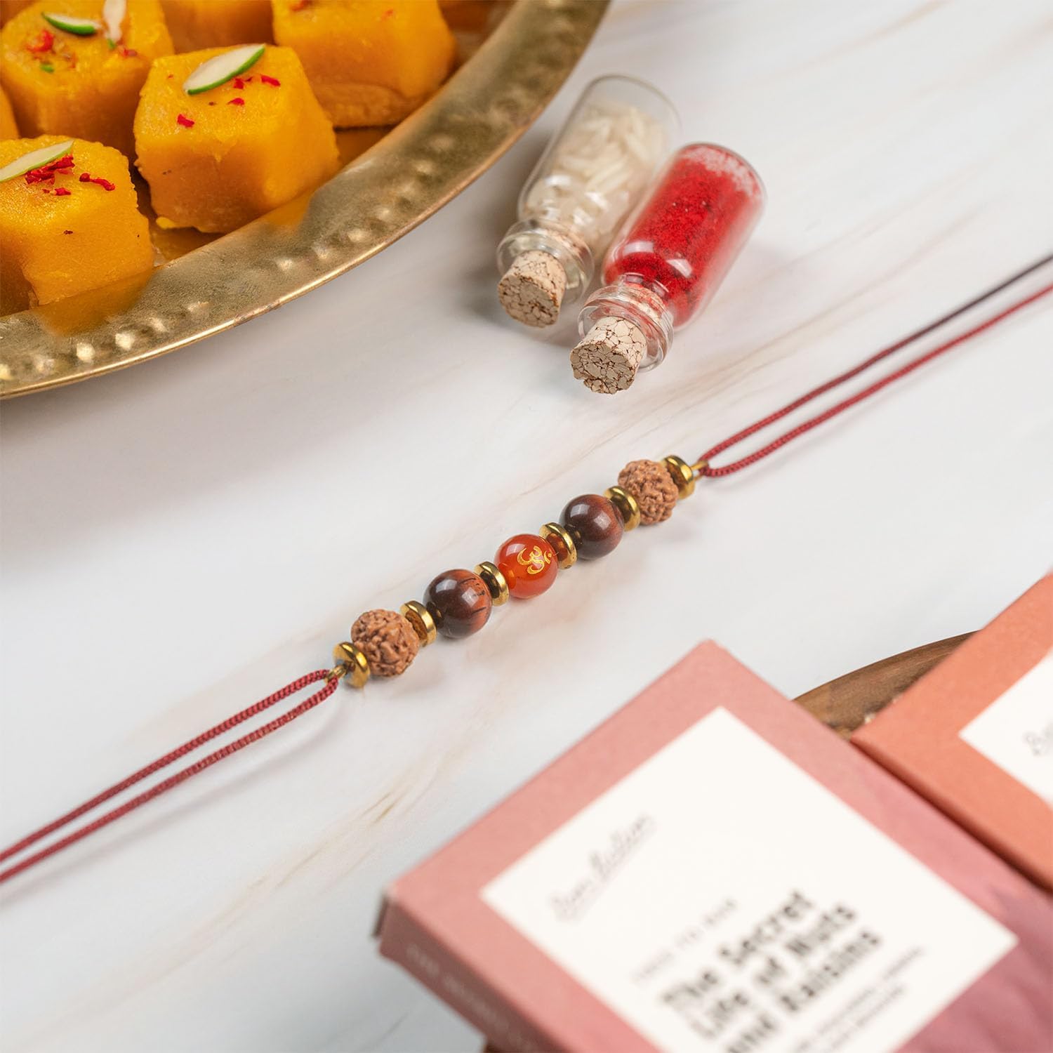 Mesmerize Natural Certified Stone Rakhis for Brother/Bhai/Bhaiya – Chakra, Evil Eye, Pyrite, Om | Each Includes Roli Chawal in Glass Bottles and Greeting Card