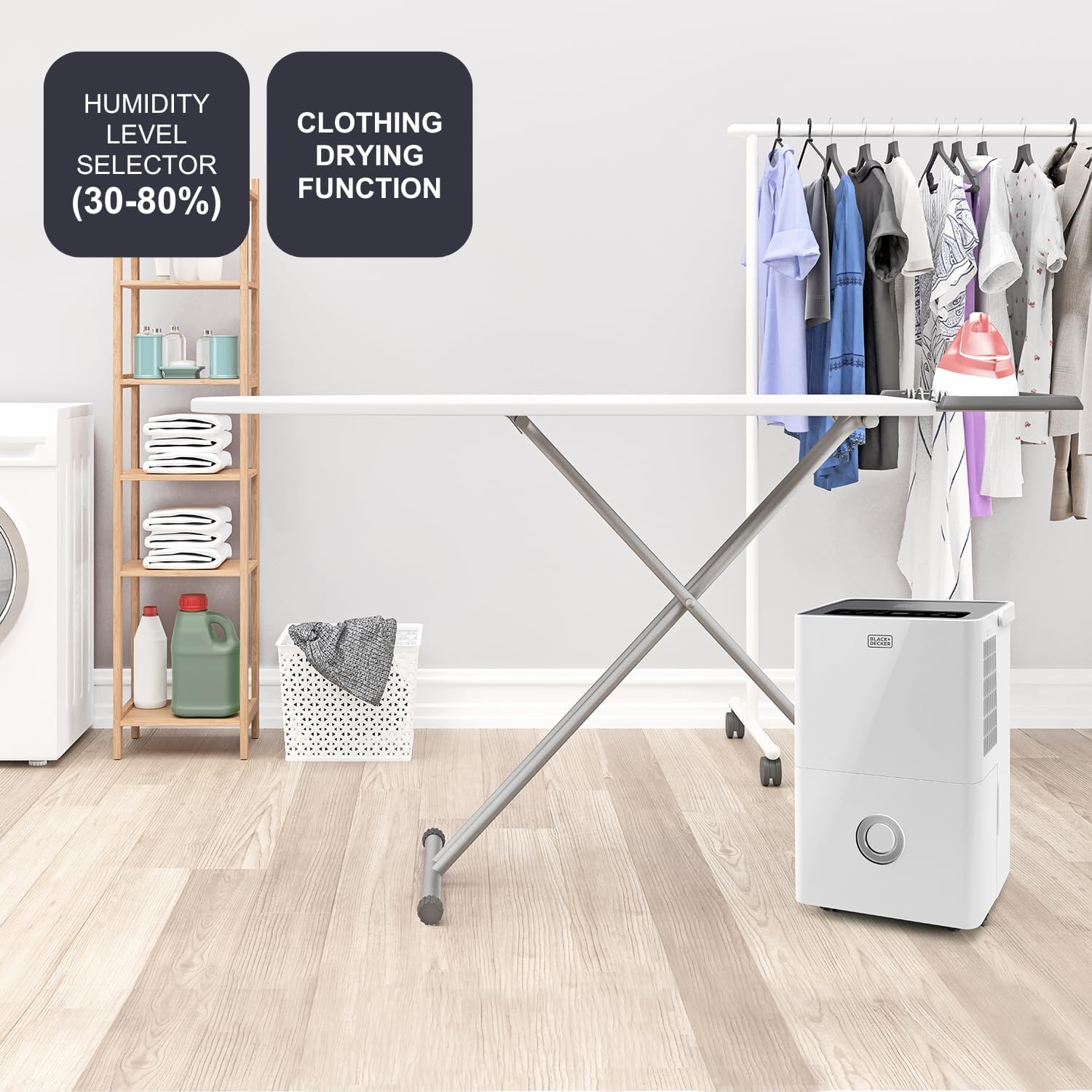 The Black+Decker BXDH20E dehumidifier next to a laundry drying rack, illustrating its humidity level selector (30-80%) and clothing drying function.