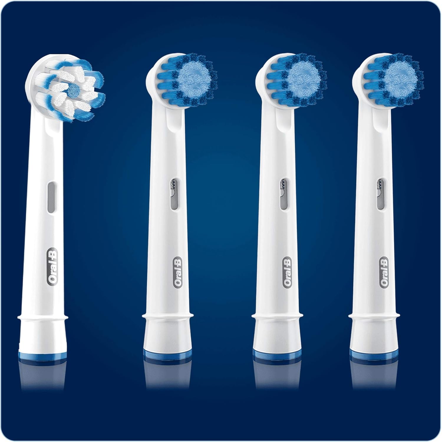 Four Oral-B replacement brush heads with different colored rings at the base
