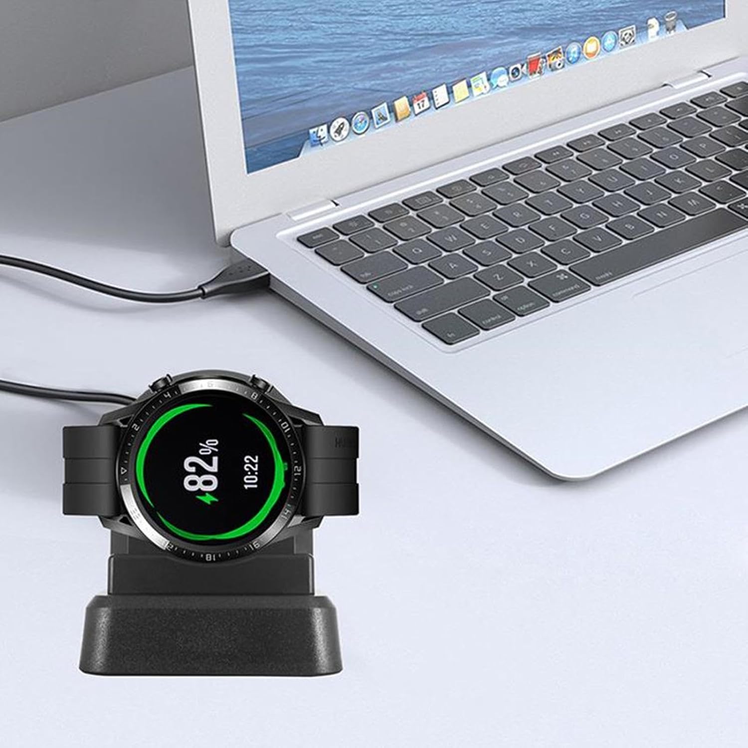 Smartwatch charger stand connected to a laptop via USB, with a smartwatch placed on the charging dock