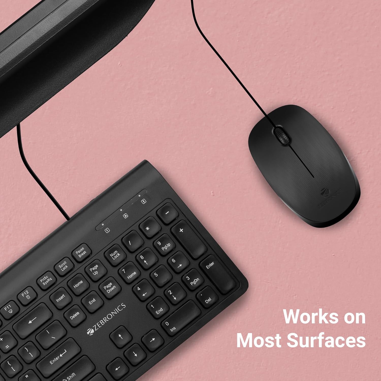 Zeb-Power mouse on a desk next to a keyboard, indicating it works on most surfaces