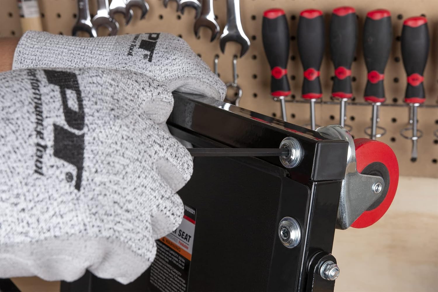Person using a T-handle wrench to assemble furniture