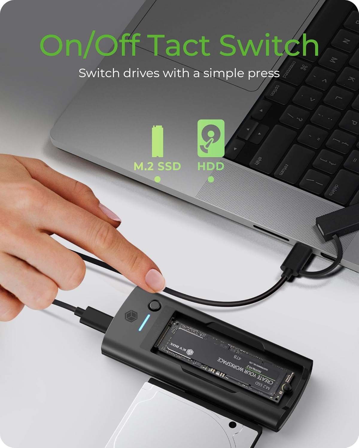 Hand pressing the tact switch on the ICY BOX docking station to switch between M.2 SSD and HDD