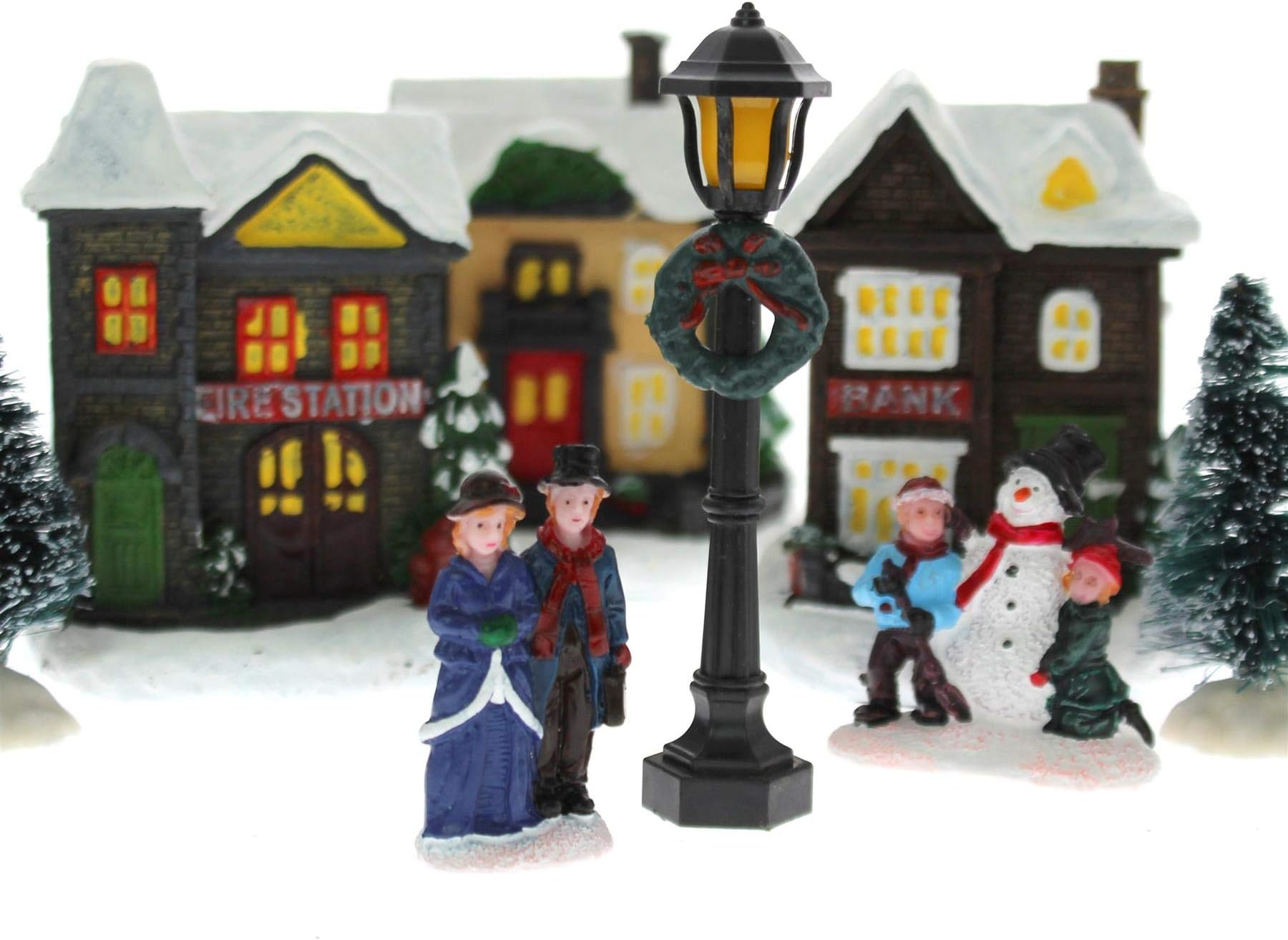 iTrend Light Up LED Christmas Village Snow Covered Scene Figurines Snowman Trees House Shops