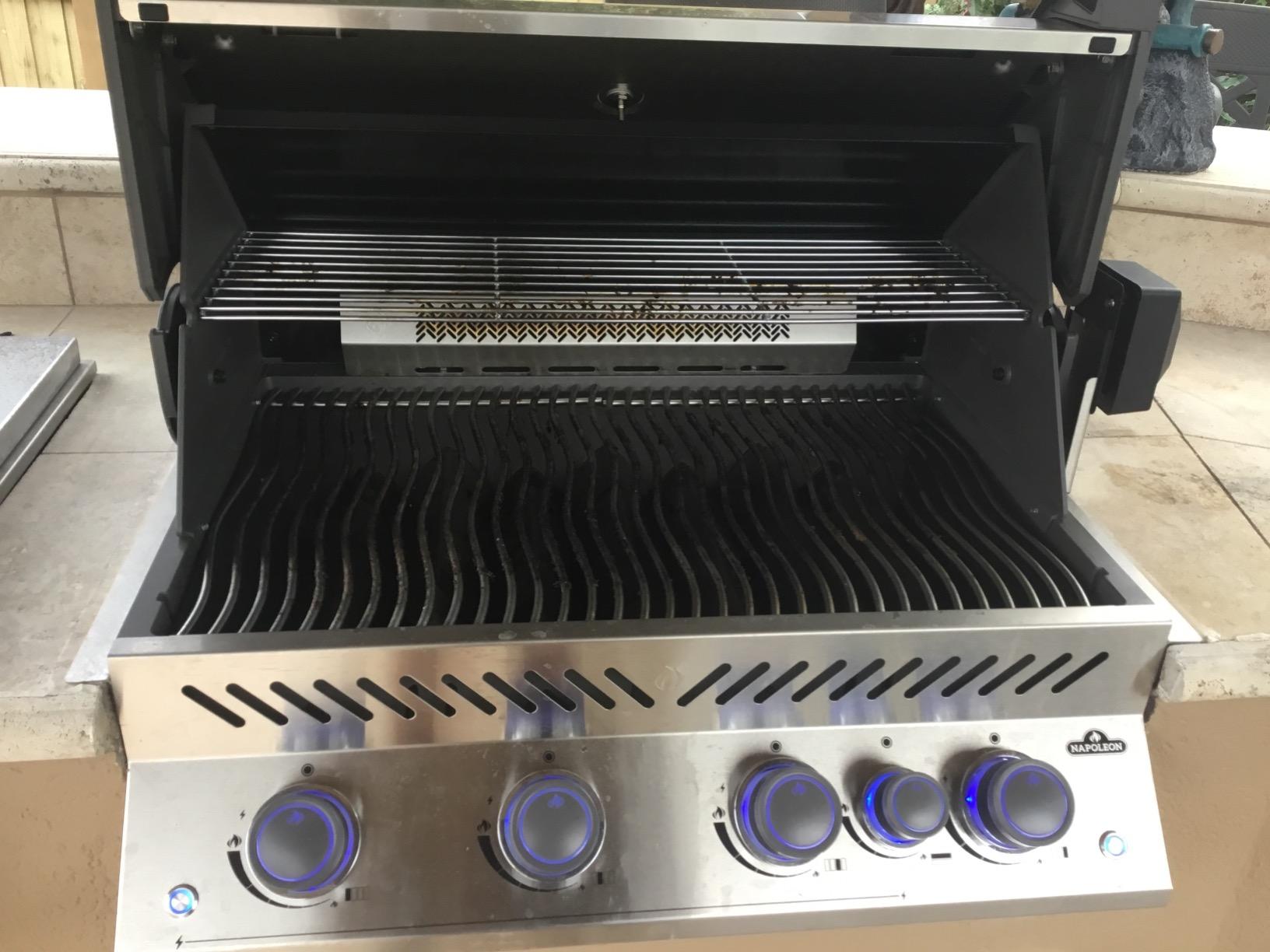 Close-up of premium gas grill stainless steel burners and cooking grates
