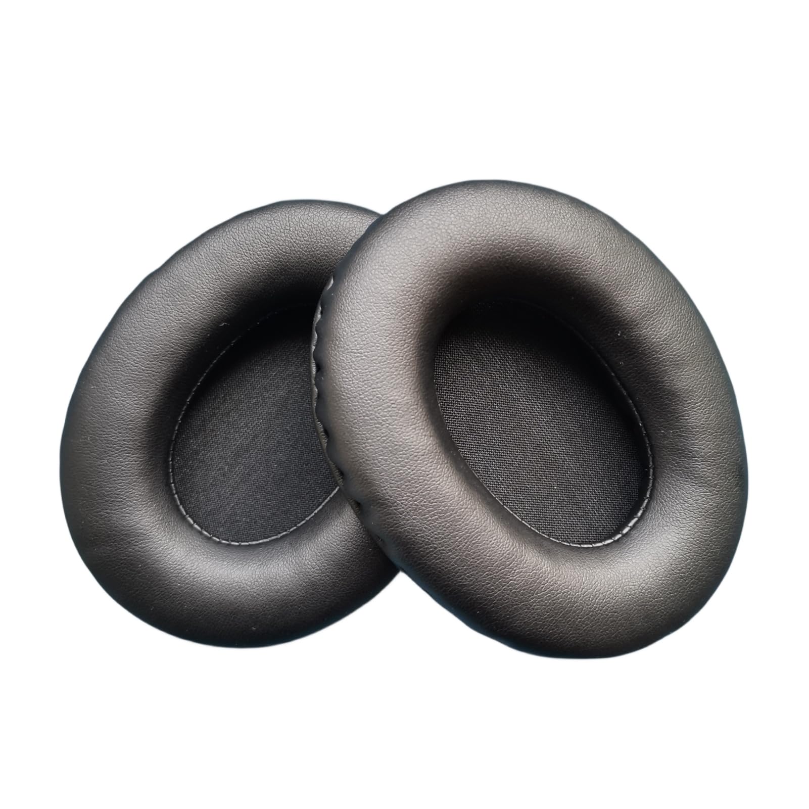 Two black replacement ear pads viewed from an angle, highlighting their thickness and soft texture.