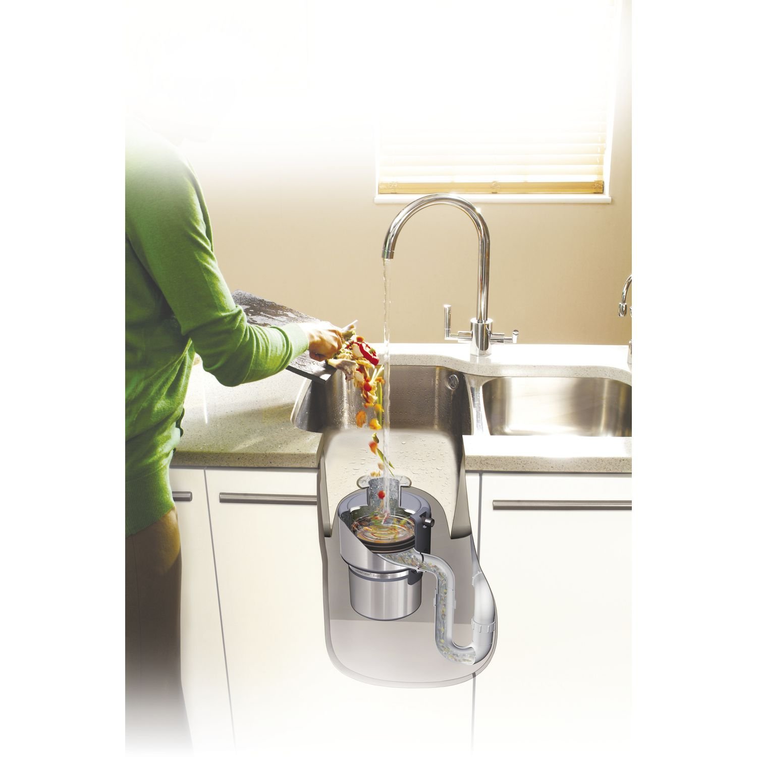 Cutaway diagram showing food waste disposer installed under a kitchen sink