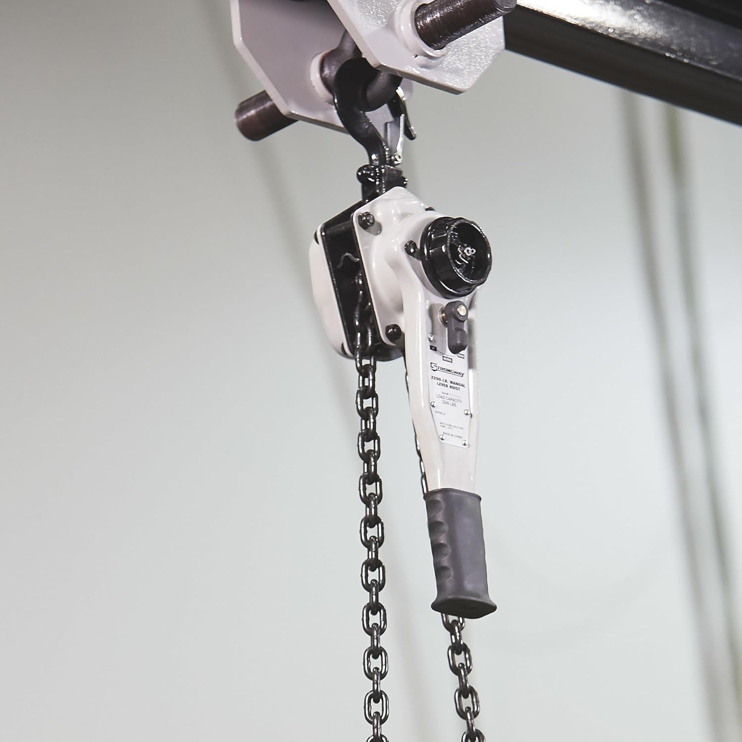 Strongway Lever Chain Hoist suspended from an overhead beam.