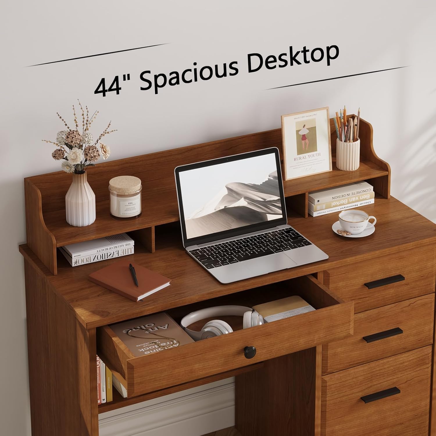 Close-up of the desk's spacious desktop with a laptop and an open drawer containing various items.