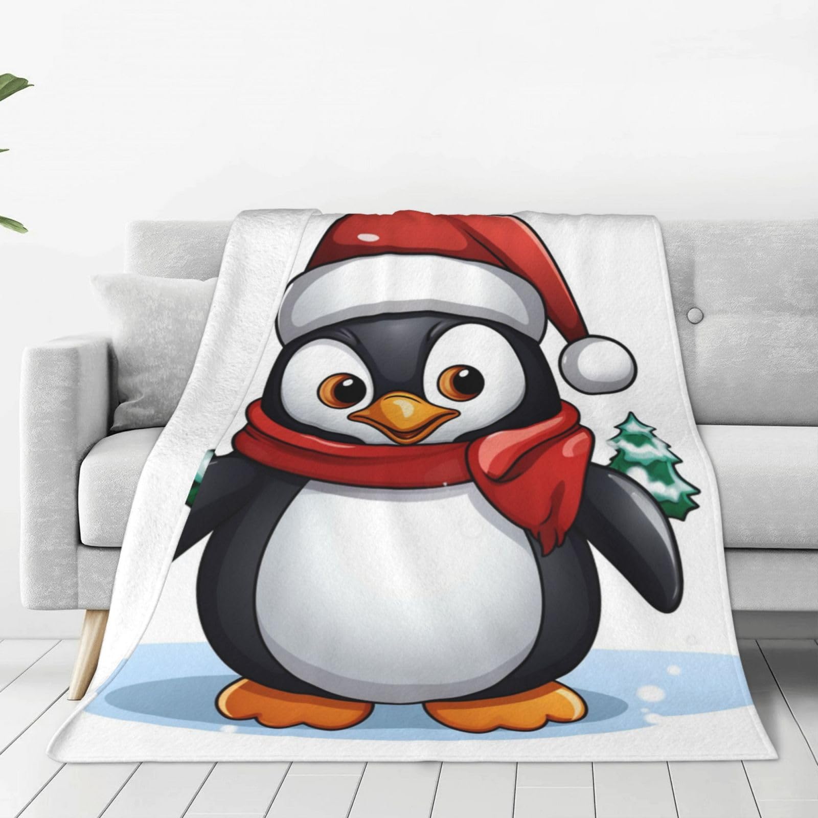 Couverture polaire pingouin pour un Noël cocooning sur votre canapé