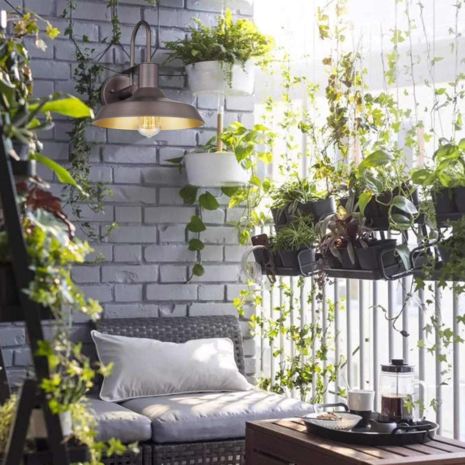Darkaway Gooseneck Barn Light installed on an outdoor balcony or patio wall, illuminating a seating area.