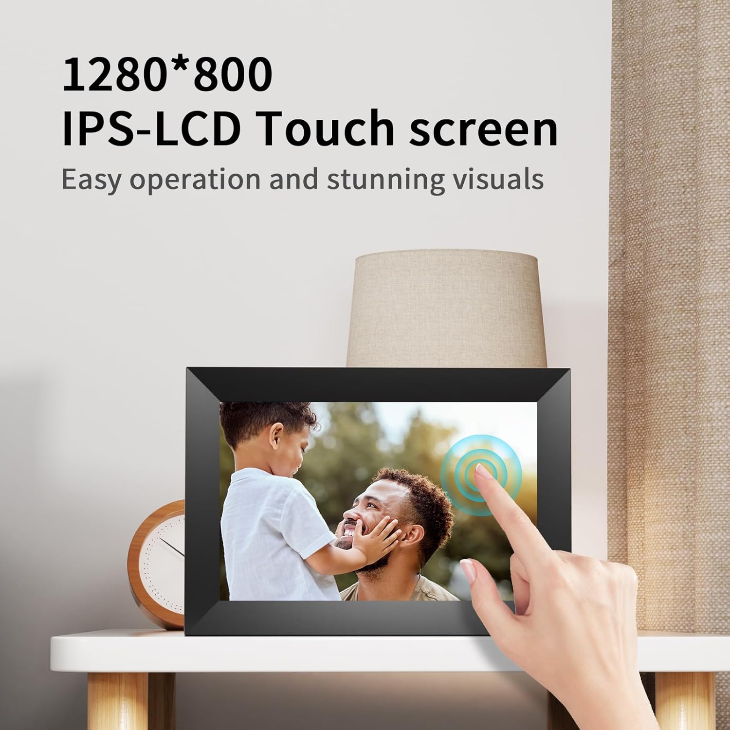 A hand touching the screen of the digital picture frame, illustrating the touch screen functionality.