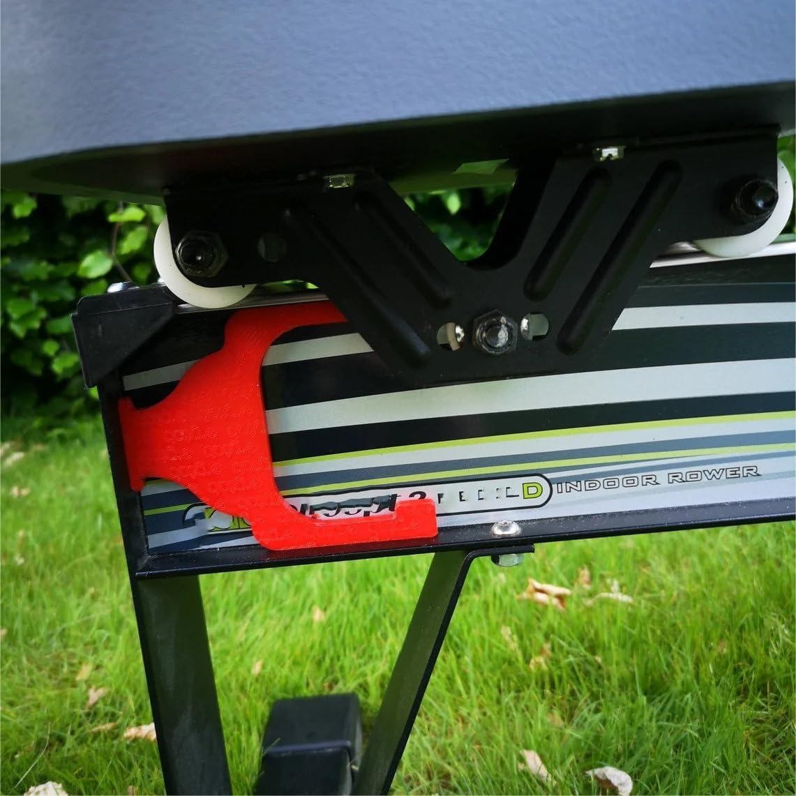 Ergtab handle support holding the rower handle in a stored position on the side of the Concept2 rower.