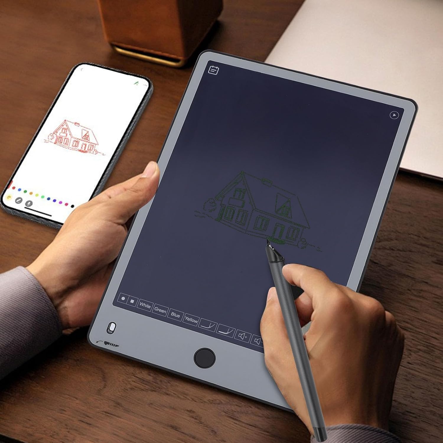 User writing on digital notepad with phone showing real-time sync