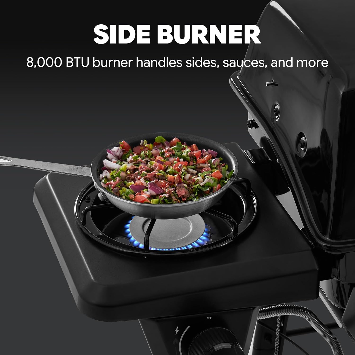 Close-up of the Feasto grill's side burner with a pan cooking food, showing the flame.