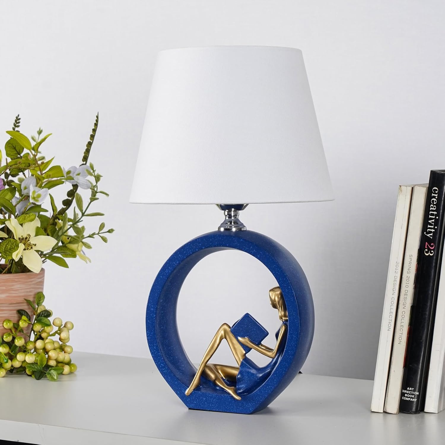 Decorative Table Lamp with Reading Figure Base, Blue and Gold, Circular Resin Base, White Shade, 17.3 Inch Height
