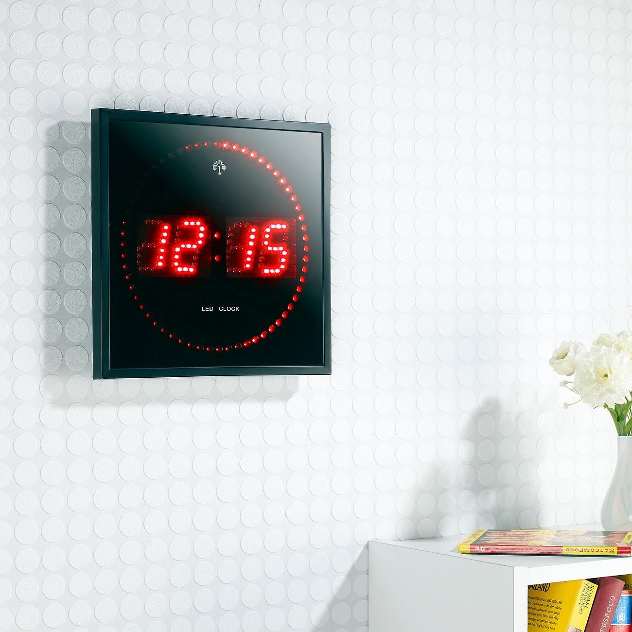 Lunartec Radio-Controlled Digital LED Wall Clock mounted on a white textured wall in a room setting.
