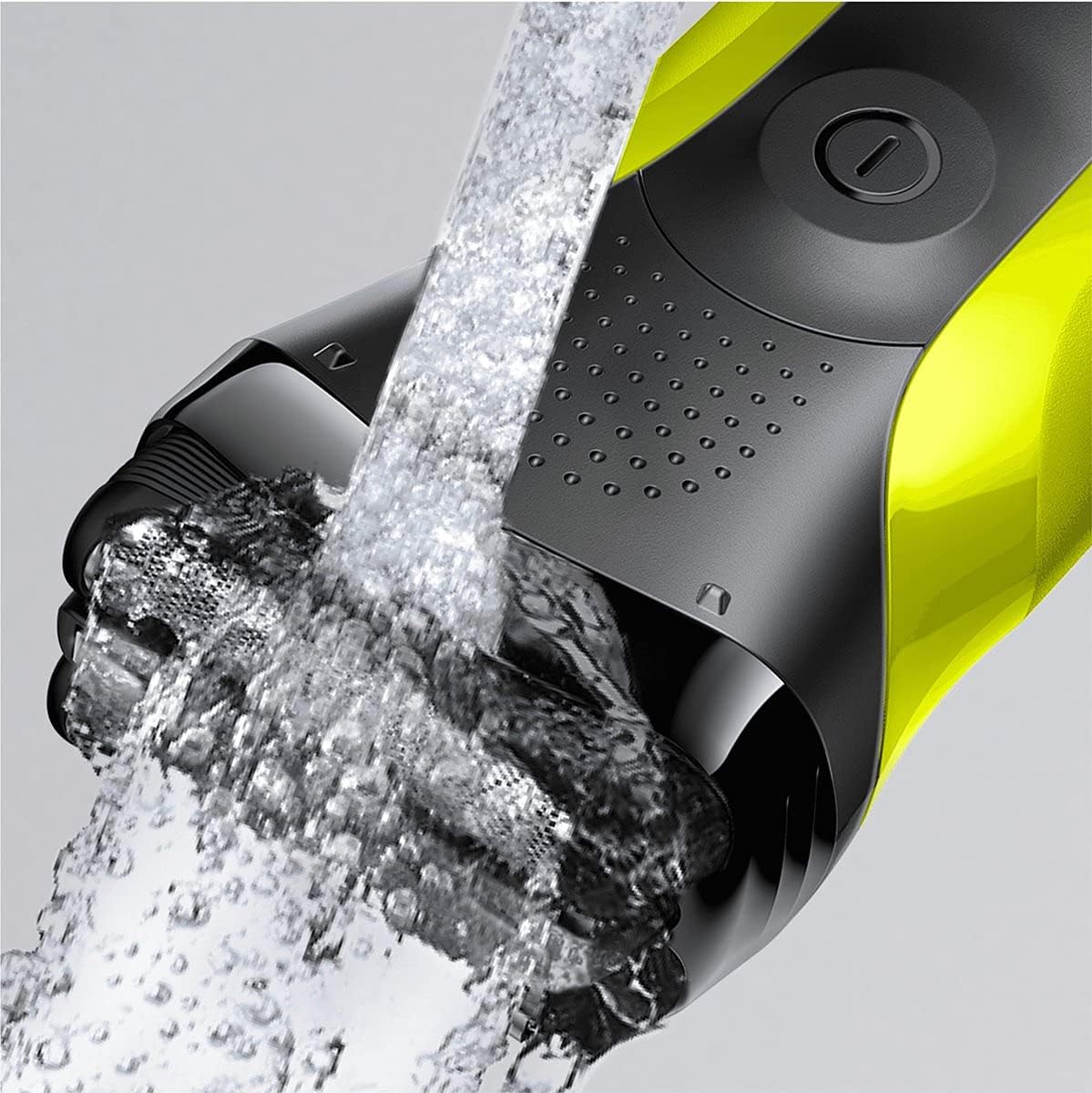 The Braun Series 3 Shave&Style 300BT shaver being rinsed under a stream of water, demonstrating its waterproof cleaning capability.