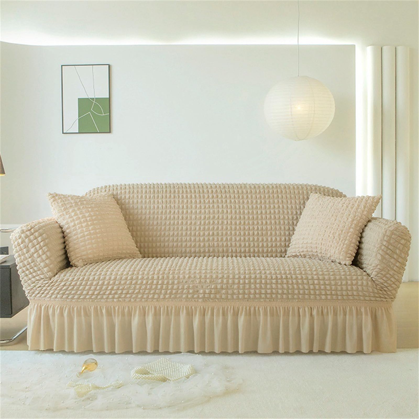 Housse de canapé extensible beige pour protéger le fauteuil du salon des animaux
