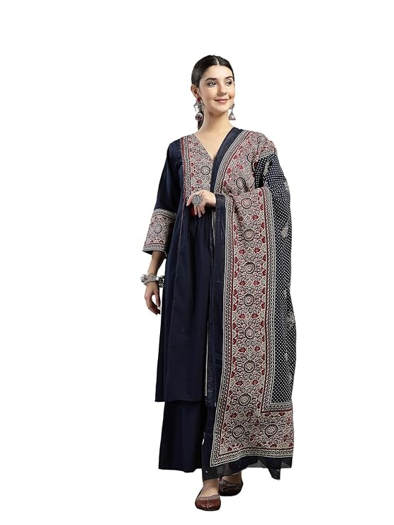 Woman wearing a navy blue A-line kurta with Ajrakh-printed dupatta draped over the shoulder. The kurta features printed border detailing at the neckline and cuffs, paired with matching wide-leg navy pants.