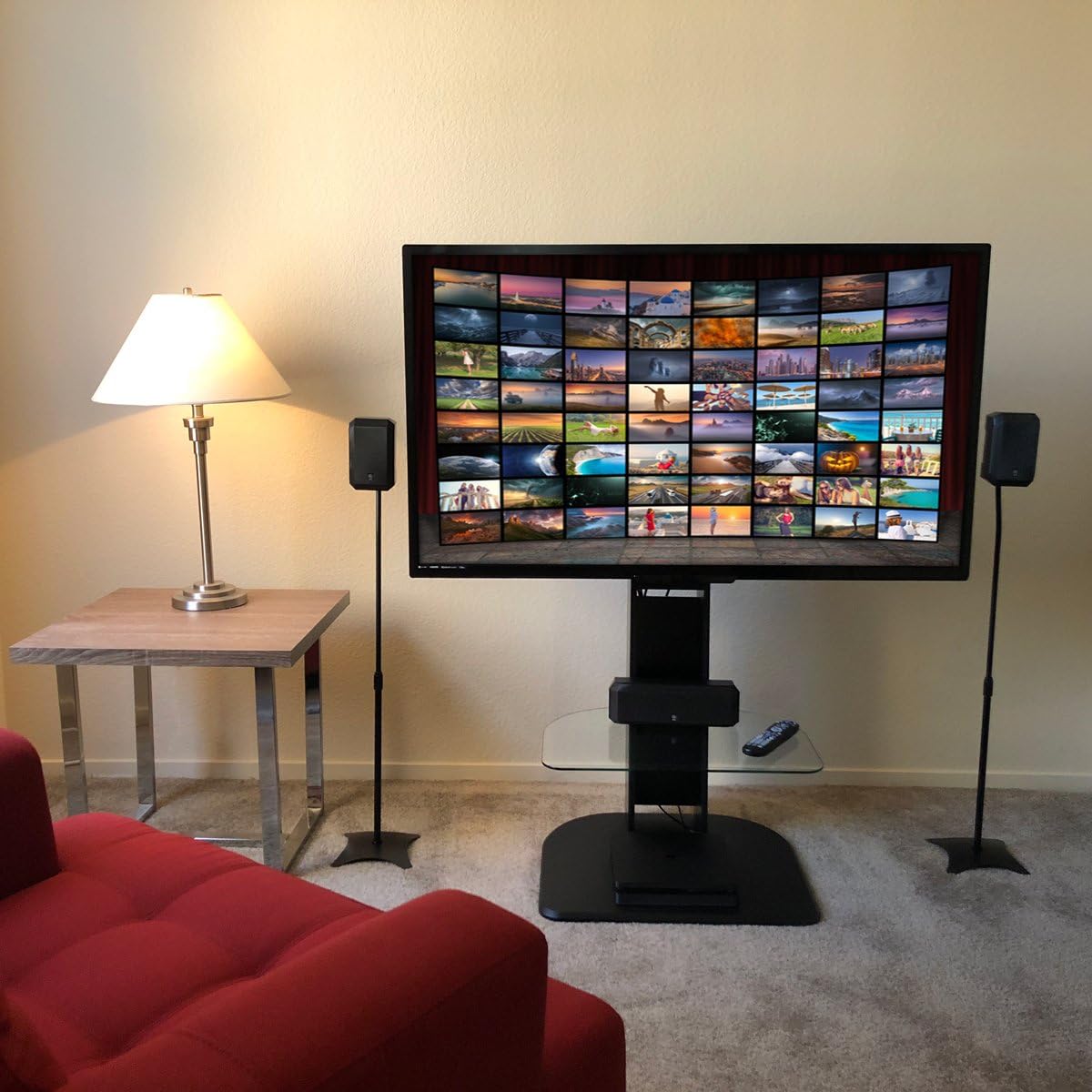 Minify speaker stands with speakers in a living room setup next to a TV