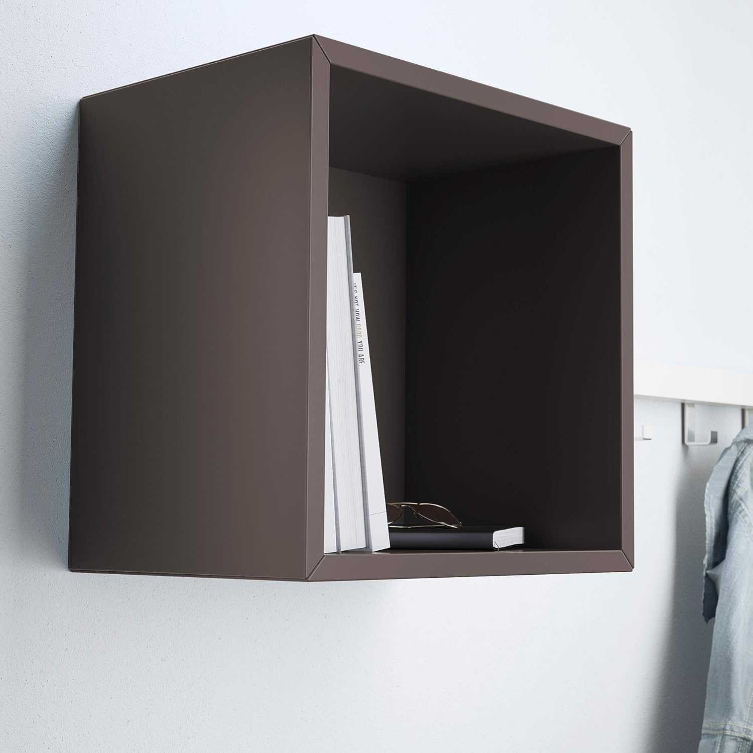 Dark grey EKET unit mounted on a white wall, holding books and glasses