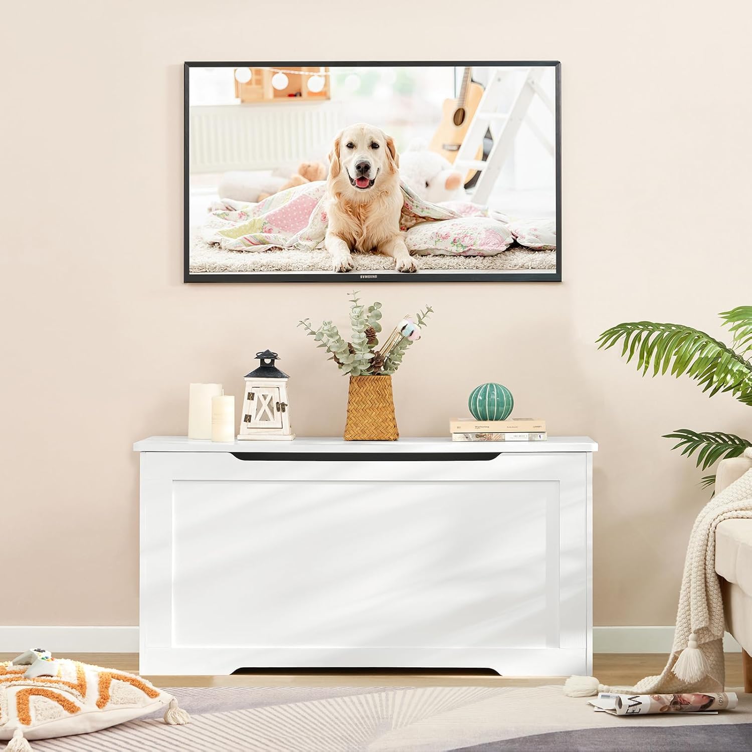 usikey toy chest used as a TV stand in a living room, with a television mounted above it.