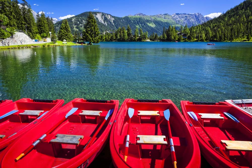 PosterazziDPI12511099LARGE Red Boats Lined Lake Under Blue Sky with a Mountain Range in The Background Champex, Valais, Switzerland Photo Print, 36 x 24, Multi