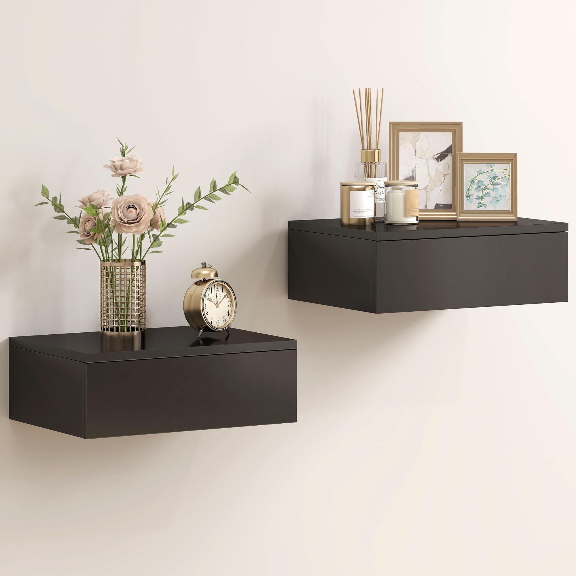 Two black floating nightstands mounted on a wall, one with a clock and books, the other with a vase of flowers and a radio.