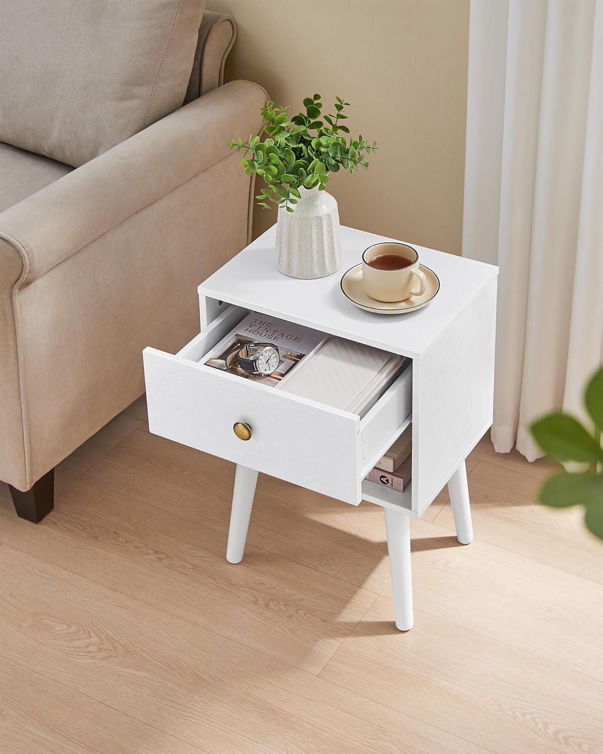 Nightstand with an open drawer, showing items stored inside and on the open shelf